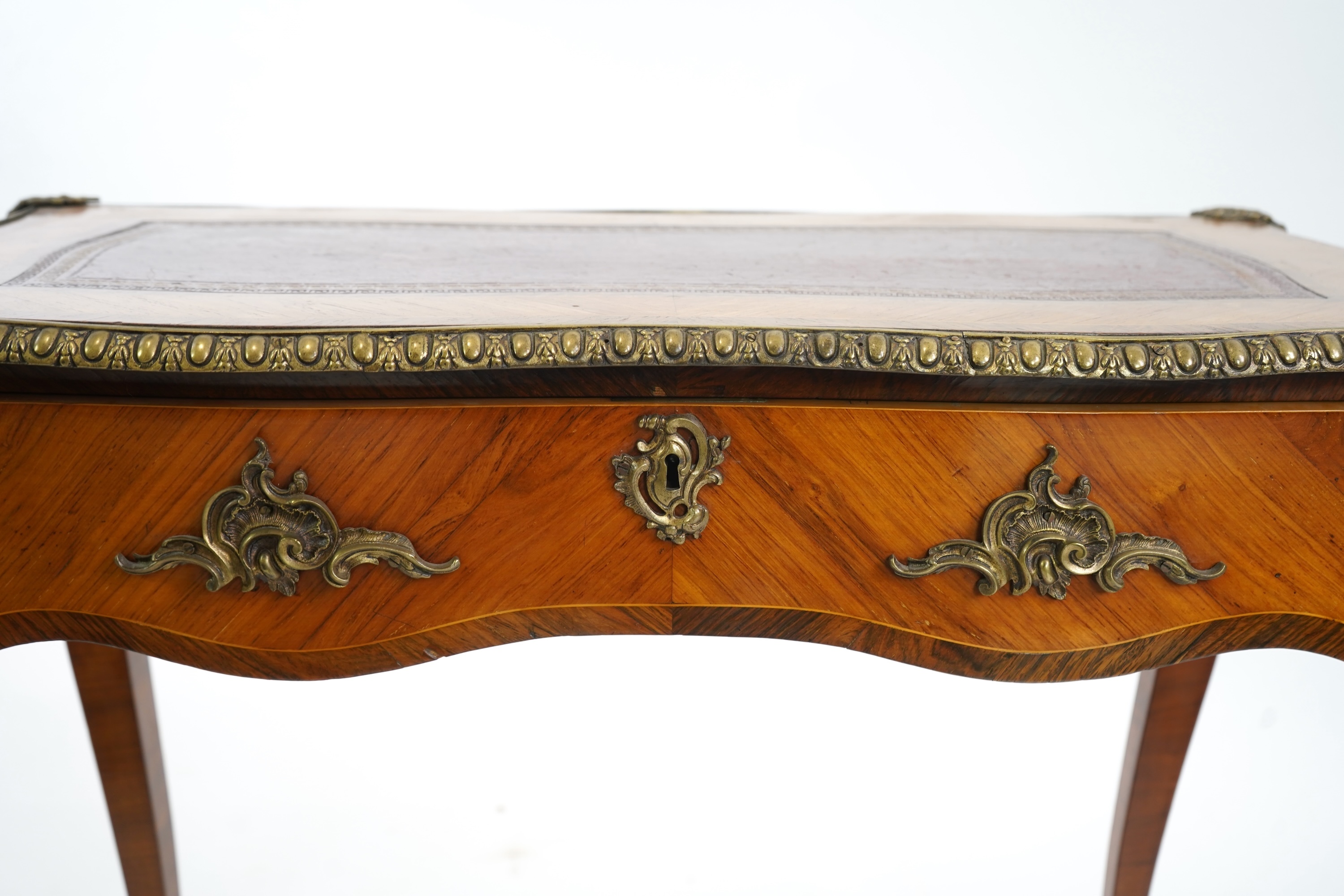 A small Louis XV style gilt metal mounted rosewood and kingwood bureau plat